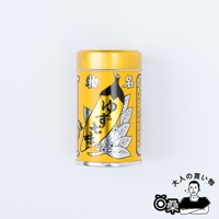 黃色金屬罐裝柚子七味粉，罐身印有黑色的辣椒圖案、綠葉與白色小花，以及日文「柚子七味」字樣。