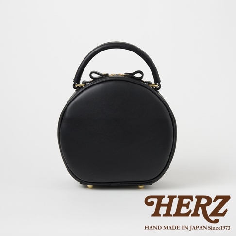 日本HERZ手工製作黑色皮革圓形手提包，附有金色拉鍊和蝴蝶結裝飾