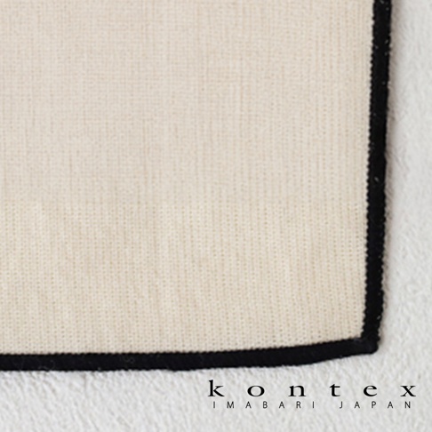 這是一張 KONTEX 今治和紙有機棉快乾廚房大拭巾的局部特寫圖，呈現米白色編織布料的細膩質感，邊緣以黑色縫線收邊，下方印有 KONTEX IMABARI JAPAN 的品牌標誌。