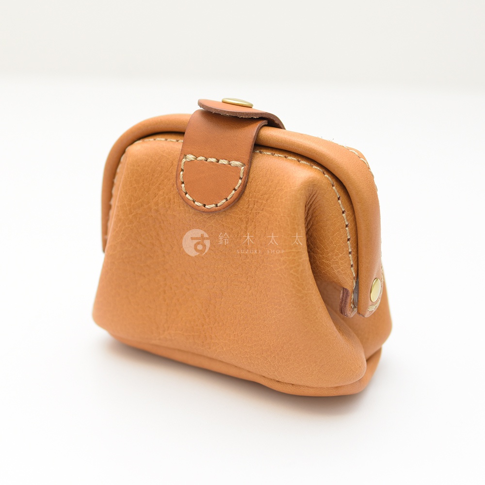 職人手作皮革口金化妝包，採用質感棕色皮革，設有金屬釦帶開合，搭配縫線細節，造型簡約。