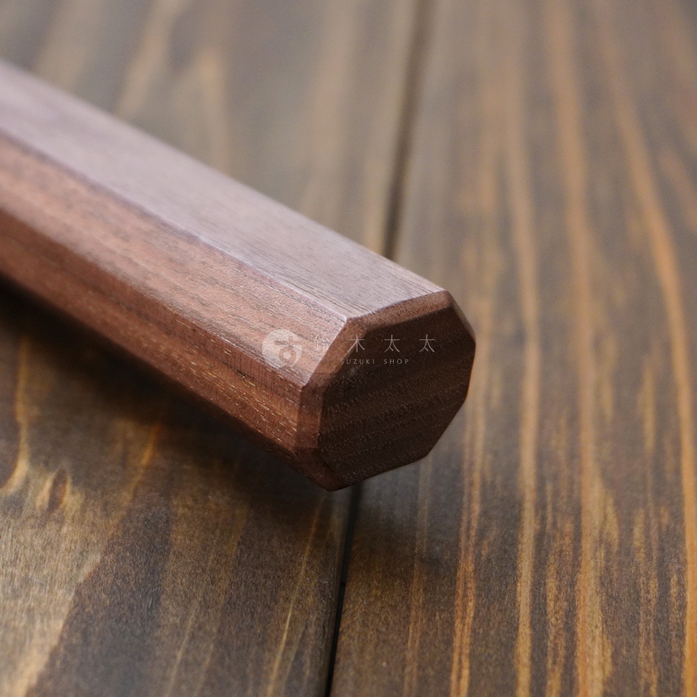 [景清] Chromax鋼三德刀的胡桃木刀柄，呈現深棕色，八角形設計，木紋細膩，質感厚實。