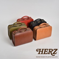 五款職人手作皮革兩用方形單肩包，顏色包含棕色、綠色、紅色、黑色及橘棕色，皆為真皮材質，帶有拉鍊開合與提把。