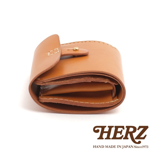 職人手作皮革原子釦型二折式短夾，採用自然棕色皮革，設有銅製原子釦，整體風格簡約，展現皮革的自然紋理與手工質感。