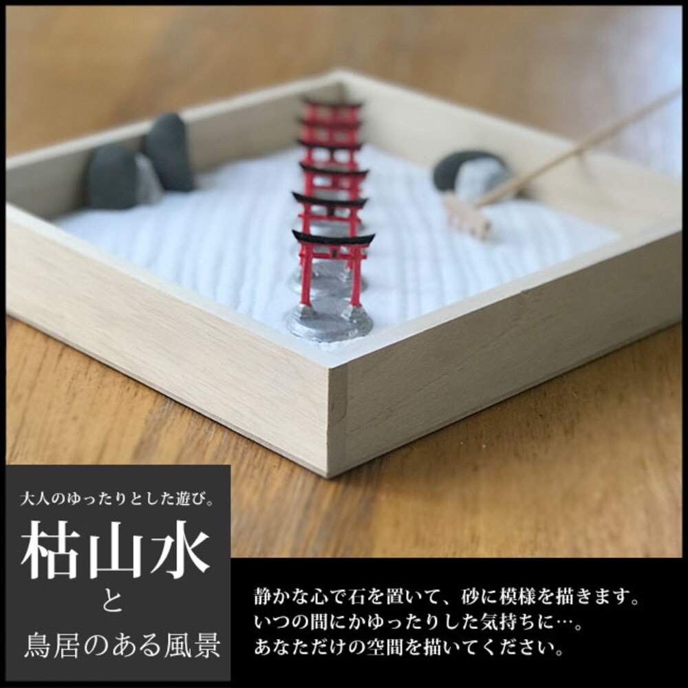 日本枯山水模型，木製淺盤裝飾著白色細沙，擺放著一排紅色鳥居、灰色石塊及一把小耙子。
