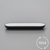 黑色的長方形固體皂，帶有圓潤的邊緣，皂體為白色，置於灰色背景上。