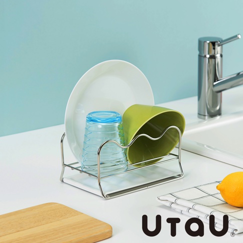 不鏽鋼多功能萬用瀝水支架，架上置有白色圓盤、藍色條紋玻璃杯及綠色杯子，整體為簡約線條設計。