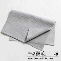 灰色的棉麻混紡拭巾，表面有鬆餅紋理，一角疊起，展現細緻的織紋。