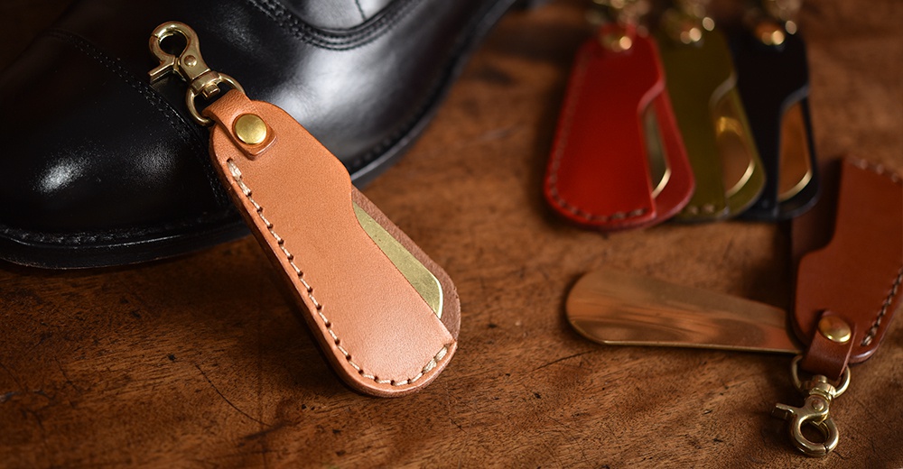 皮質鞋拔，內嵌金屬，附有鑰匙圈，有棕色、紅色、綠色、黑色等顏色，皮革邊緣縫線整齊，金屬部分光澤亮麗。