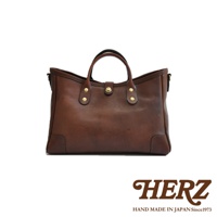 職人手作皮革托特包，深棕色，簡約設計，配有雙提把和金色金屬扣，適合日常攜帶。