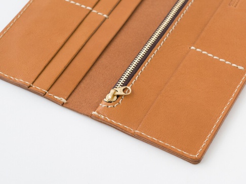 出来る限り薄く仕上げるため、小銭入れや札入れのマチは設けていません。又、ファスナーの革引手もあえて取り付けていません。