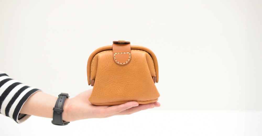 職人手作皮革口金化妝包 KF-143 S，淺棕色，材質為皮革，具有復古口金閉合設計，車縫線清晰。