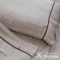 米白色今治五層紗枕套，帶有深棕色滾邊，枕套一角有藍、白、紅三色織標。