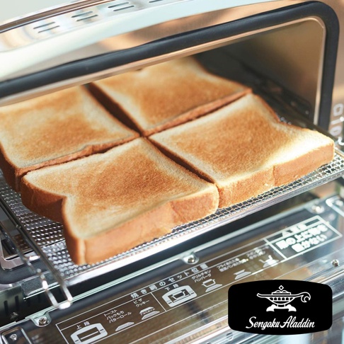 烤箱內有四片剛烤好的吐司，吐司呈現金黃色，放在金屬烤網上。