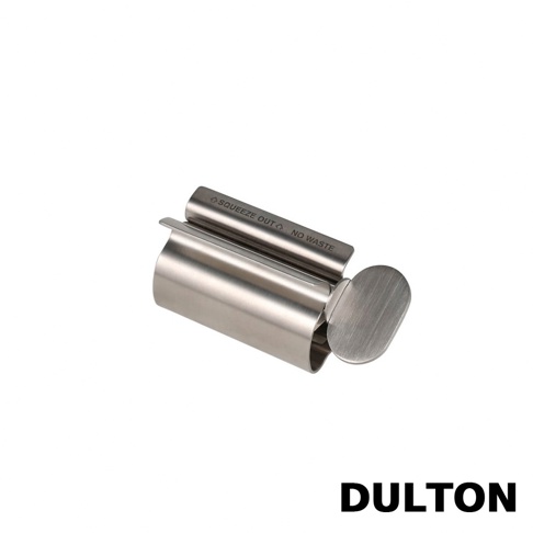 一個 DULTON 金屬質感的不鏽鋼轉轉擠牙膏器，上方刻有 SQUEEZE OUT NO WASTE 的英文字樣，側面配有扁平的旋轉握把，整體設計簡約實用。