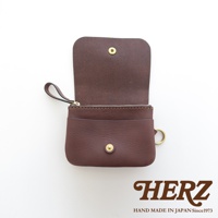 深棕色皮革，雙層結構，附有拉鍊開口、按扣蓋和掛環。