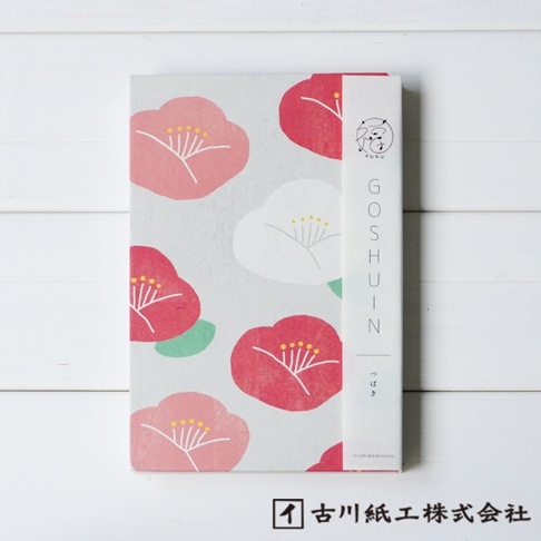 美濃和紙福氣御朱印帳，封面印有粉紅、紅色與白色的山茶花圖案，背景為淺灰色，紙質紋理清晰。右側束帶印有「GOSHÜIN」字樣及日文「つばき」。