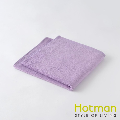 一條疊好的紫色毛巾，材質為柔軟的毛圈織物，邊緣有縫線。