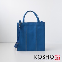 藍色棉帆布扇形托特包，有兩個提把和一條可拆卸肩帶，包身有垂直縫線裝飾。