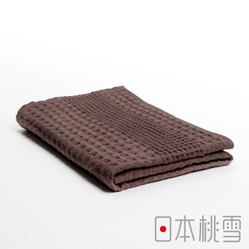 一條深棕色、具有格子紋理的今治鬆餅浴巾，對折放置於白色背景上。