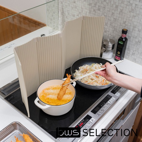 米白色六片式摺疊防油隔板，展開於廚房IH爐上，用於油炸食物，隔板上有垂直紋路，中央的鍋中正炸著一隻炸蝦。