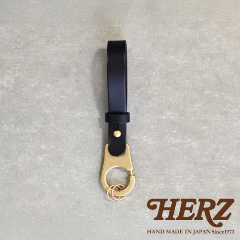 黑色皮革鑰匙圈，配有黃銅色鉤扣和三個銅色鑰匙圈。