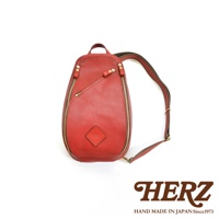 紅色皮革斜背包，設有兩個拉鍊口袋，一個斜向主開口拉鍊，以及一個正面小拉鍊。包身為鵝卵石紋理皮革，搭配金色拉鍊和金屬配件。