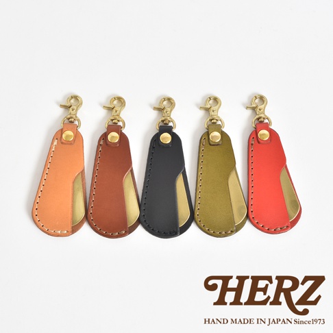 五個職人手作皮革隨身金屬鞋拔，分別為橘色、棕色、黑色、軍綠色和紅色，皆配有金色金屬掛環。