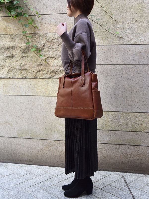 職人手作皮革直式肩背托特包，棕色皮革，簡約設計，有提把與側邊口袋，適合日常攜帶。