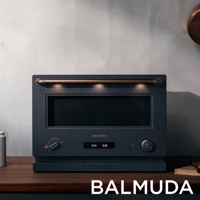 深藍色 BALMUDA 微波烤箱，配有銅色把手和現代化操作面板，簡約設計。
