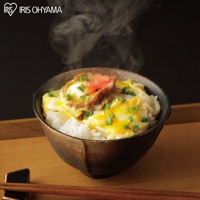 一碗熱騰騰的越光米飯，鋪上金黃滑嫩的炒蛋、雞肉塊，撒上翠綠蔥花與粉紅薑片，裝在樸實的陶碗中，散發著誘人的香氣。