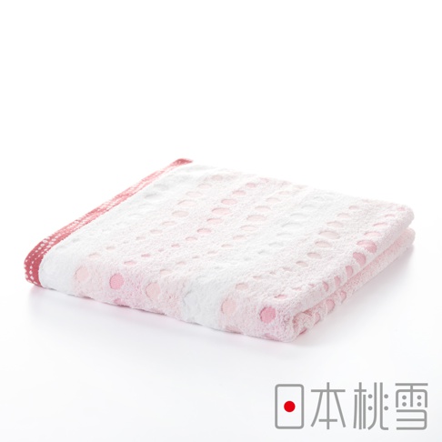 一條粉紅色水泡泡圖案的今治毛巾，材質柔軟，邊緣有紅色滾邊，毛巾對折展示。
