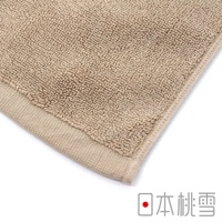 淺褐色毛圈浴墊，具有明顯的織紋和邊緣縫線。