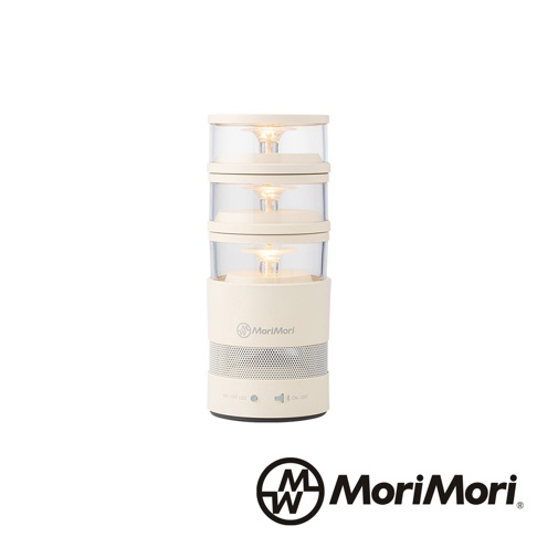 松本素白LASMO Speaker 燭光氣氛音響，圓柱形設計，上層為堆疊的透明圓筒，內置暖色LED燈，底部為米白色喇叭網罩，印有MoriMori品牌標誌，側面有操作按鈕。
