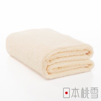 一條折疊的淺米色今治超長棉浴巾，質地柔軟蓬鬆，邊緣有清晰的紋理。