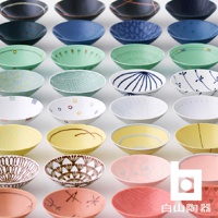 展示多款平茶碗，顏色涵蓋深藍、淺藍、綠色、黃色、粉色及白色。部分茶碗飾有精緻的圖案，包括點狀、線條、花紋及幾何圖形，材質疑似陶瓷。