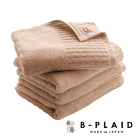 堆疊的米色 RIB 今治浴巾，材質柔軟，表面帶有直條紋織紋，頂端浴巾角落有品牌標誌。