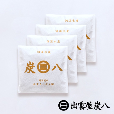 四件白色包裝的調濕木炭，以金色字體印有「調濕木炭」和品牌標誌。