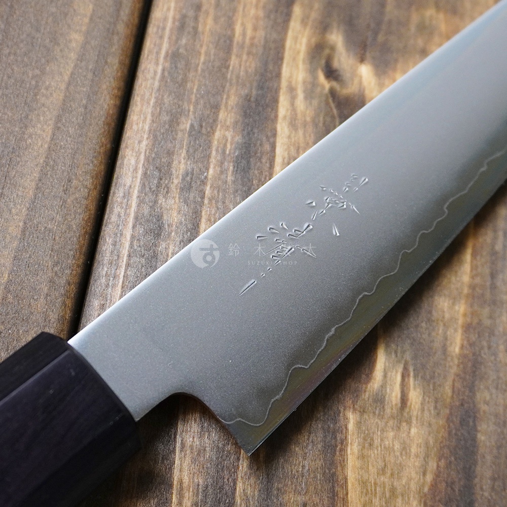 [景清] Chromax鋼水果刀，刀刃為銀色金屬材質，刀柄為深棕色胡桃木，刀身上有細緻的日文蝕刻圖案與波浪紋路。