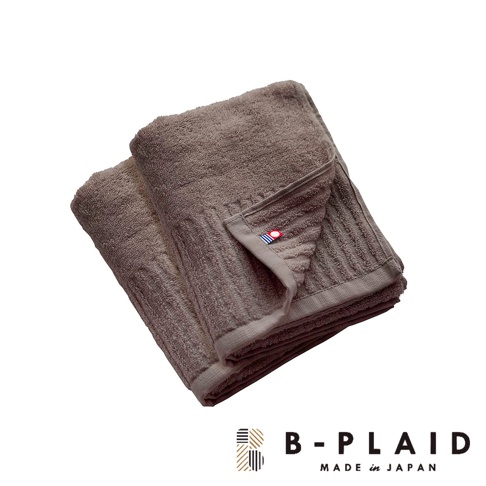 今治長毛柔暖速乾直紋毛巾，深棕色，柔軟舒適，織有明顯的直條紋理，左上角有藍、白、紅三色標籤。