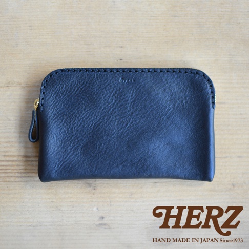 黑色皮革製的Organ雙拉鍊收納袋，配有金色拉鍊和皮革拉環，材質表面帶有自然紋理。