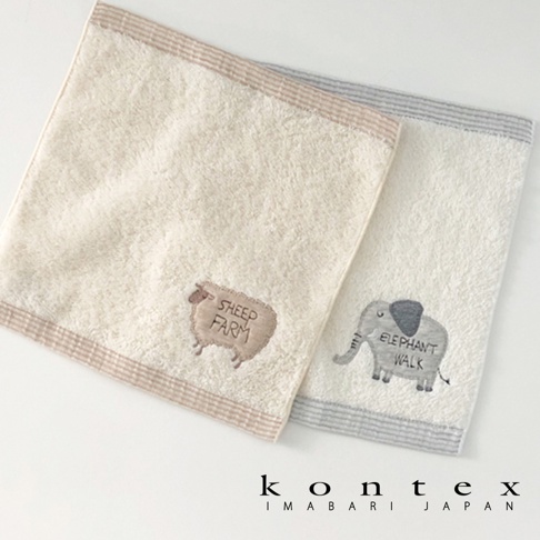 兩條今治純棉手帕，一條為米白色，繡有棕色綿羊圖案及「SHEEP FARM」字樣，邊緣為棕色條紋；另一條為淺灰色，繡有灰色大象圖案及「ELEPHANT WALK」字樣，邊緣為灰色條紋。