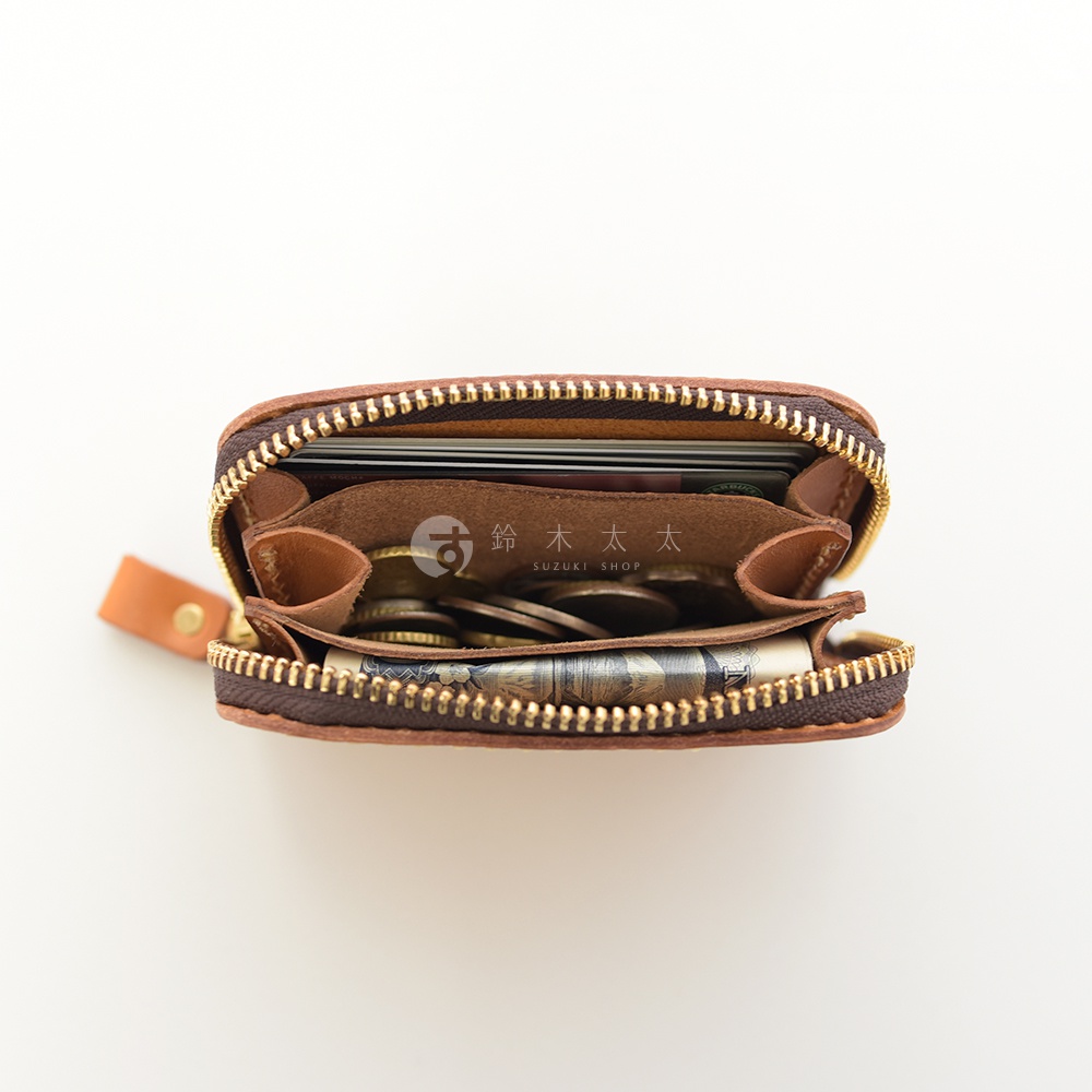 職人手作皮革高機能收納錢包，棕色皮革材質，拉鍊開合，內部可見多個隔層，裝有信用卡、硬幣及紙鈔。