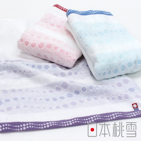 今治水泡泡毛巾，包含粉紅色、淺藍色和淡紫色三款。毛巾表面織有細小的圓點圖案，邊緣有裝飾條紋，材質柔軟。
