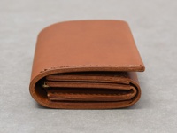 職人手作皮革Organ雙折迷你短夾，呈現溫潤的棕褐色，由光滑皮革製成，縫線整齊，側面可見多層卡槽設計。