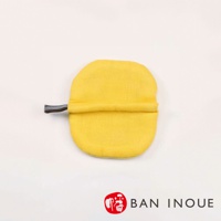 黃色蚊帳質地防燙鍋套，帶有灰色條紋織帶，用於隔熱。