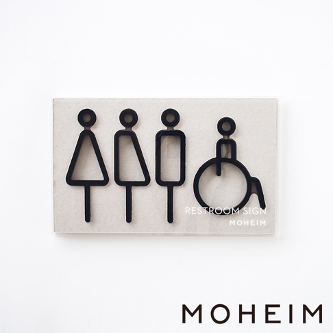 一組四個黑色廁所標示牌，包含女性、男性、無障礙人士符號，置於淺色背景板上。