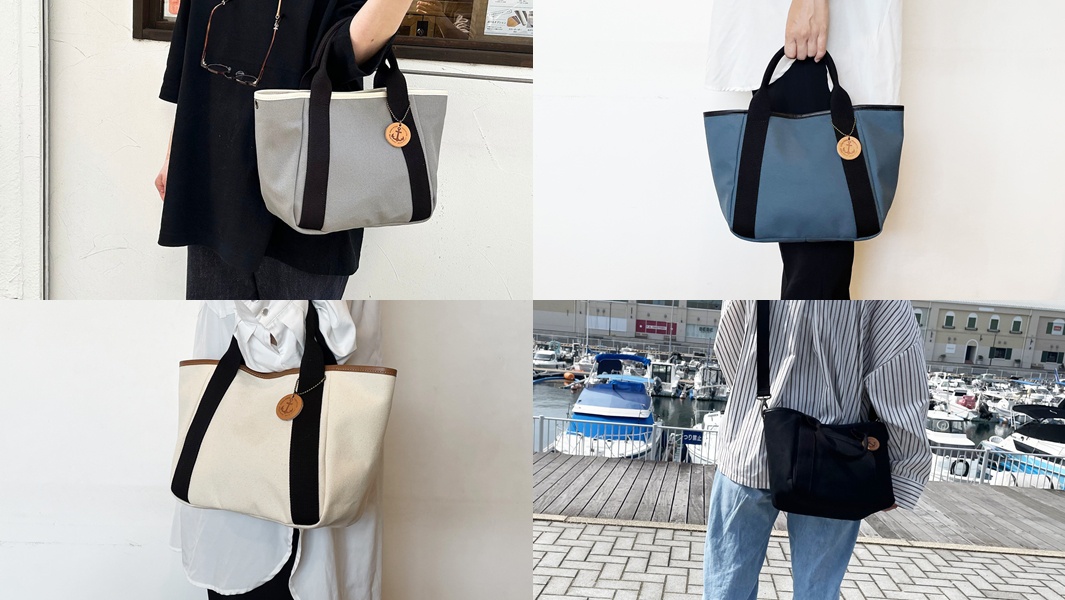 展示高島帆布製成的多口袋手提托特包，顏色有灰色、藍色、米白色和黑色。包包採用帆布材質，配有對比色的織帶和提把，並裝飾有船錨造型的吊牌。