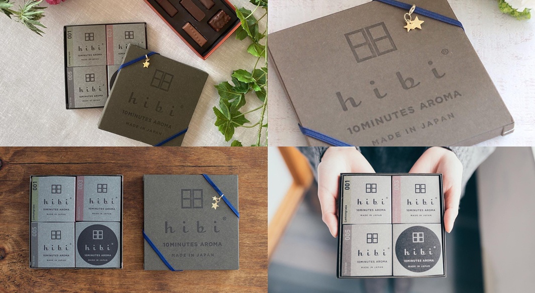 灰褐色紙盒包裝的香氛火柴禮盒，內含四小盒，分別標示001、003、005等編號，印有「hibi 10MINUTES AROMA MADE IN JAPAN」字樣。其中一盒外觀有用藍色緞帶綁著，並繫有金色小星星裝飾。