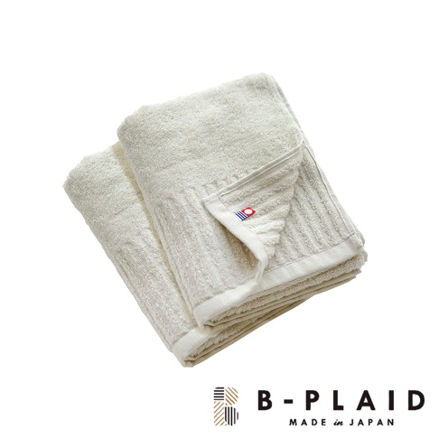 淡米白色 RIB 今治長毛柔暖速乾直紋毛巾，材質柔軟，表面有清晰的直紋織造，一角帶有紅色與藍色組成的品牌標誌。