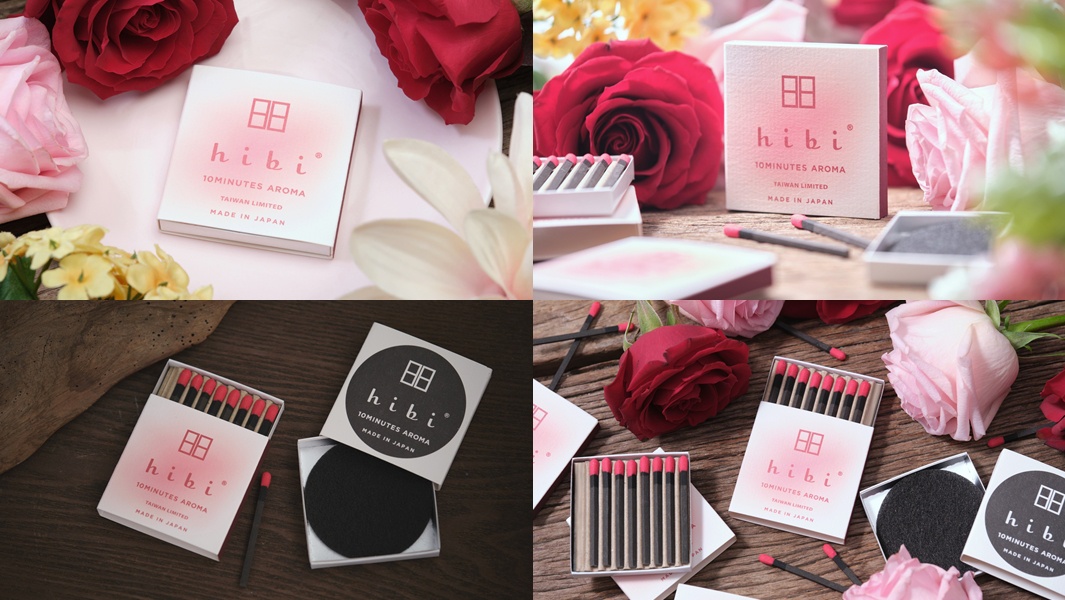 香氛火柴組合，粉色漸層紙盒內裝有黑色火柴棒，頂端為紅色，周圍環繞著紅色與粉色玫瑰。